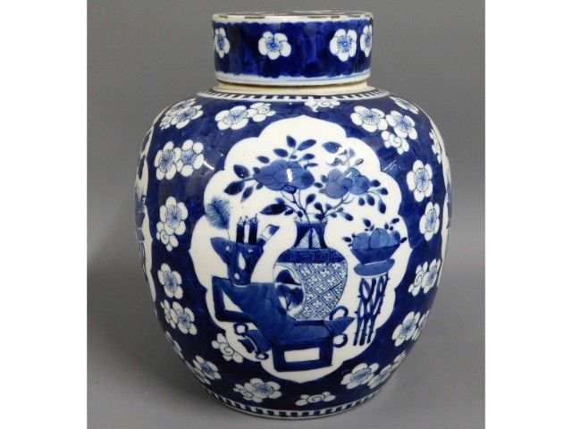 A large 19thC. Chinese blue & white lidded ginger jar with decorative panels & prunus flowers, 10.25