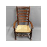 An 18thC. ladder back chair with rush seat, 41.25i