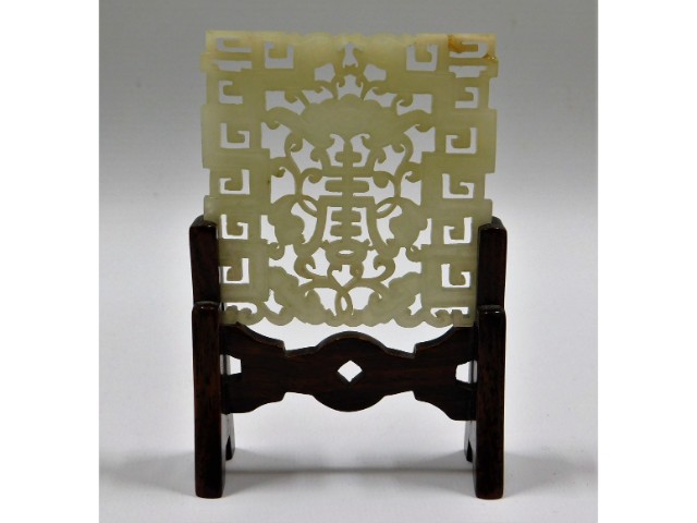 An antique carved jade fretwork, mounted on rosewo
