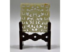 An antique carved jade fretwork, mounted on rosewo