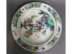 A large Chinese porcelain charger with bird decor,
