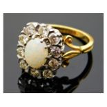An 18ct gold ring set with opal & 0.7ct diamonds,