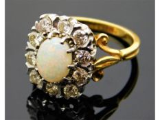 An 18ct gold ring set with opal & 0.7ct diamonds,