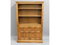 An Ercol elm bookcase, 59in high 37.5in wide x 13i