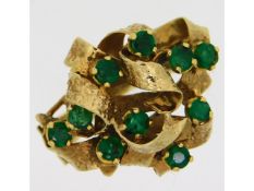 A 9ct gold ring set with ten emeralds of 3mm diame