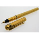 A Cartier gold plated ball point pen with three colour gold plated band to top, some wear & bump to