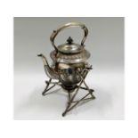 A Victorian silver plated spirit kettle on organic