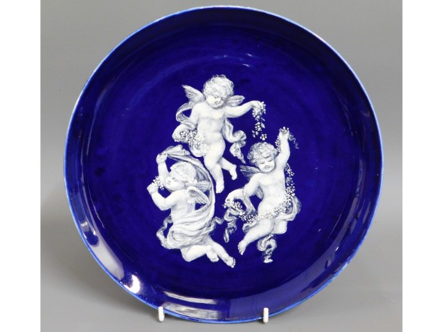 A 19thC. pate sur pate cobalt blue plate, given as