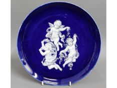 A 19thC. pate sur pate cobalt blue plate, given as