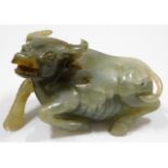 An antique carved jade water buffalo, fault/repair