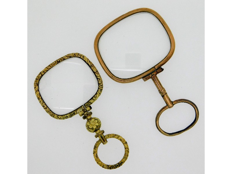 A yellow metal lorgnette with carved decor, chip t