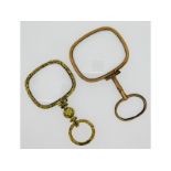 A yellow metal lorgnette with carved decor, chip t