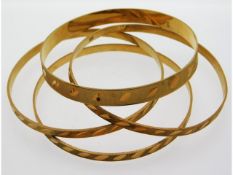 Four yellow metal bangles, test as 20ct gold, 50.79g