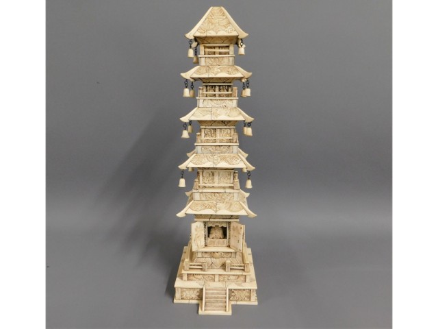 A 19thC. Chinese carved ivory tower with small Bud