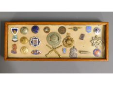 A cased selection of mixed badges & buttons includ