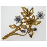 A 9ct gold brooch of organic form set with approx.