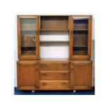 An Ercol elm sideboard with glazed cupboards over