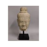 A life size carved Tibetan stone head, 19in tall