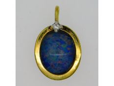 A 9ct gold pendant with opal doublet & small diamo