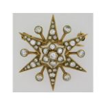 A 9ct gold star shaped brooch set with white stones, 32mm wide, 6.62g