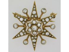 A 9ct gold star shaped brooch set with white stones, 32mm wide, 6.62g