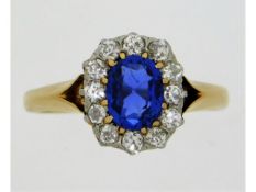 An antique yellow metal ring, tests electronically as 18ct gold, set with sapphire style stone & app