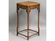 A 19thC. Chinese hardwood stand with carved decor,