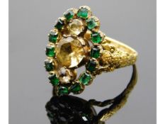 A yellow metal 19thC. emerald & yellow topaz ring