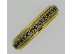 An 18ct two colour gold eternity ring set with sma