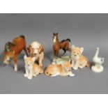 Three Russian porcelain lion cubs, two horse figur