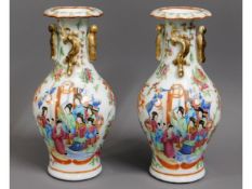 A pair of 19thC. Chinese porcelain vases with figurative decor, one repaired, 9.25in high