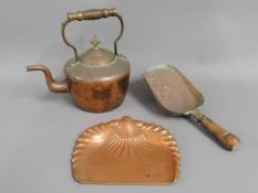 An antique copper kettle twinned with copper coal