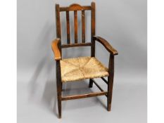A child's oak rush seat chair, 27in high to back