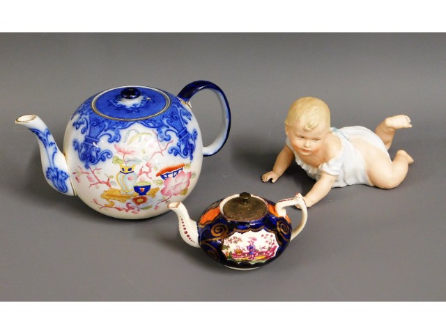 A German bisque porcelain model of crawling baby, 7in long, twinned with two antique teapots with Ch