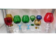 A large cranberry wine glass & other decorative gl