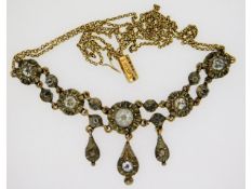 An art deco, 1920's yellow & white metal necklace,