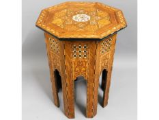 An octagonal Islamic inlaid table, 24.5in high x 1