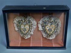 A pair of cased early 20thC. sweetheart cushions,