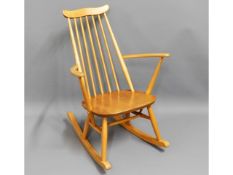 A blond Ercol elm rocking chair, 33in high