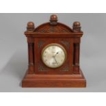 A wooden Genalex electric clock, 10.75in high