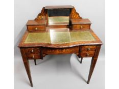 An antique inlaid rosewood desk with mirrored back