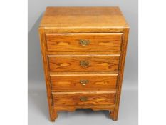 A oak chest of four drawers, 35.25in high x 23in w