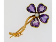 A 15ct gold floral brooch set with amethyst & pear