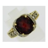 A 14ct gold ring set with diamond & garnet, size R