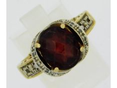 A 14ct gold ring set with diamond & garnet, size R