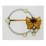 A yellow & white metal brooch set with pearl & rub