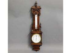 A Negretti & Zambra oak barometer with carved figu