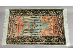 An Islamic silk prayer mat, 45in x 27in