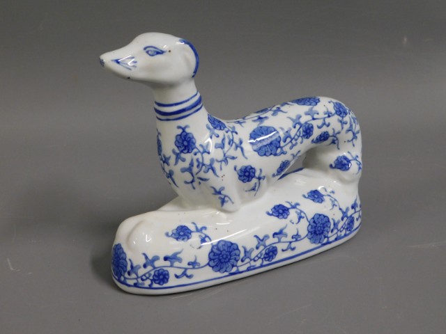 A delft style model of recumbent sighthound, 7in l