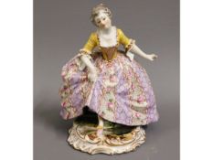 An Austrian Vienna porcelain figure of woman raisi